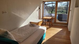a living room with a couch and a window at Hotel Lethehof in Wardenburg +25 photos