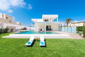 a villa with a swimming pool and a house at Villa Myrto in Ialyssos