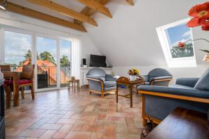 a living room with a couch and chairs and a table at Uferpromenade Whg OG in Röbel