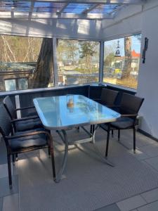 a glass table and chairs on a balcony at Bungalow "Strandblick" in Göhren