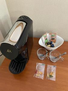 a blender on a table next to a plate of food at Andamur San Román in San Román