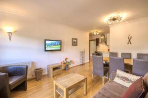 a living room with a couch and a table at Select Top 7 - by Alpen Apartments in Aufhausen