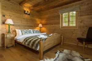 a bedroom with a bed in a log cabin at Chalet Jessica in La Tzoumaz +18 photos