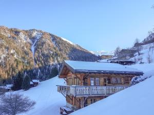 a log cabin in the snow with a mountain at Chalet Jessica in La Tzoumaz
