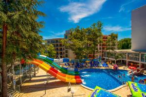 a pool with a water slide at a resort at Prestige Deluxe Hotel Aquapark Club - All inclusive in Golden Sands