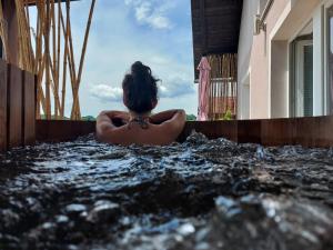 a woman sitting in a jacuzzi tub at Apartment Ma&Ja with Hot Tub in Metlika