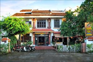 a building with motorcycles parked in front of it at Thanh Van 1 Hotel in Hoi An