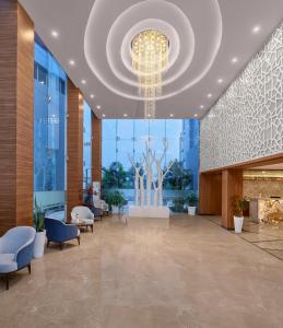 a lobby with a large chandelier in a building at Soaltee Westend Itahari in Itahari