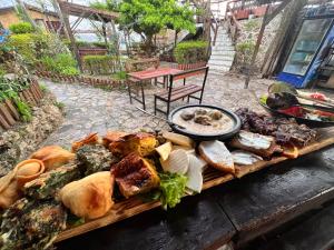 a table filled with lots of different types of food at Rooms Merlika -Inside the Castle- in Krujë
