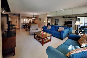 - un salon avec des canapés bleus et une table dans l'établissement Edgewater Villa 2203, à Panama City Beach