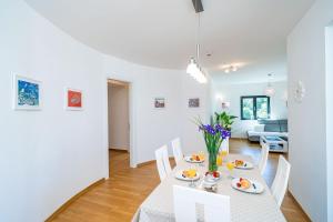 a dining room and living room with a table and chairs at Apartment Dubrovnik Clouds in Dubrovnik