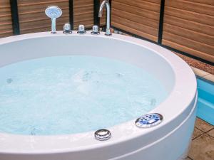 a bath tub filled with water with a faucet at Lupo Forest "GRAN FOREST Echizen Miyama" - Vacation STAY 07085v in Fukui