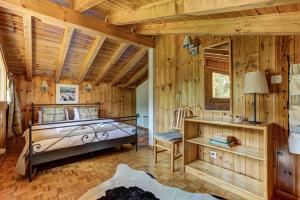 a bedroom in a log cabin with a bed and a desk at Chalet Khione in La Tzoumaz +19 photos