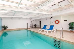 a pool with two chairs and a swimming pool at Marseille Prado Perier in Marseille