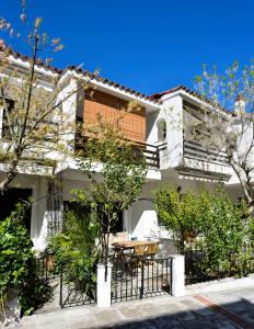 a white house with a table in front of it at Avra Chanioti in Hanioti