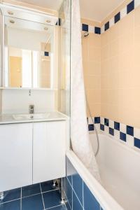 a bathroom with a white sink and a shower at Marseille Prado Perier in Marseille