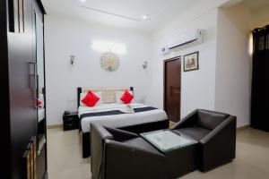 a bedroom with a bed and a couch and a chair at Elegance Resort in Jait