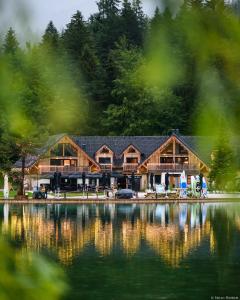 a lodge on the shore of a lake at Jasna Chalet Resort in Kranjska Gora