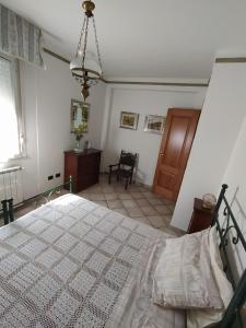 a bedroom with a bed and a chair in it at Mattoni Nel Verde in Casal Palocco