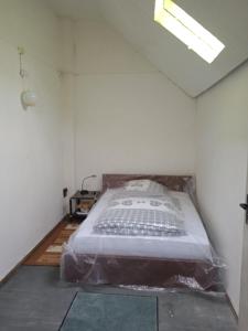 a bedroom with a bed covered in plastic at LINDENHOF WALDHEIM in Waldheim