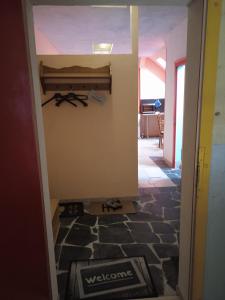 einen Flur mit Tür zu einem Zimmer mit Fliesenboden in der Unterkunft LINDENHOF WALDHEIM in Waldheim