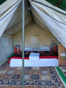 a bedroom with a bed in a tent at The Birds Hostel, Dalhousie in Dalhousie