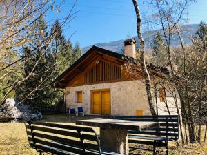 a house with a bench in front of it at Baita Oasi Nembia in San Lorenzo in Banale