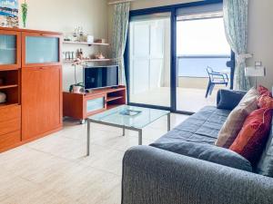 a living room with a couch and a tv at ESPACIO 8 - Primera Línea de Playa in Cullera