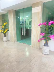two vases with flowers in them in a building at Hotel El Mirador in Ciudad Valles