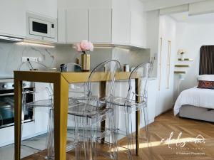 a kitchen with a table and chairs in a room at Paris Parc Monceau by Edelsam in Paris