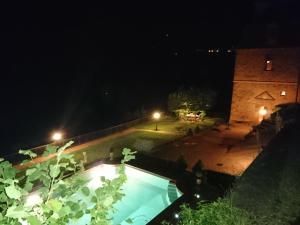 a view of a swimming pool at night at CHATEAU LA SERVAYRIE - Chambre d'hôtes in Marcillac-Vallon