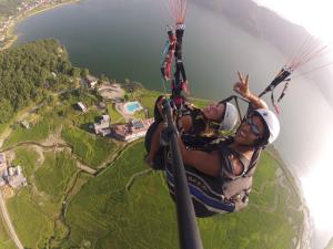 a woman is hanging from a parachute at Waterfront Resort by KGH Group in Pokhara