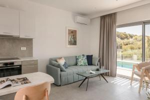 a living room with a couch and a table at Summertime Villas in Argostoli