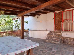 a porch of a house with a table and stairs at Villa Monte Rena in Budoni