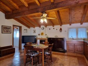 a dining room with a table and a ceiling fan at Villa Monte Rena in Budoni