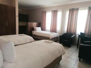Andante Guesthouse Klerksdorp客房内的一张或多张床位
