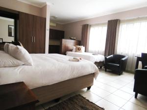 Andante Guesthouse Klerksdorp客房内的一张或多张床位