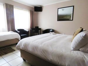 Andante Guesthouse Klerksdorp客房内的一张或多张床位