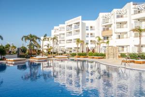 a large swimming pool in front of a building at Zahara Beach & Spa by QHotels - Adults Recommended in Zahara de los Atunes