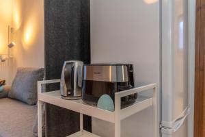 a coffee maker and microwave on a shelf in a room at Abetaia sul Lago in Alleghe