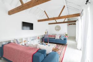 a living room with two blue couches and a rug at Simple Coastal Luxury near Southwold sleeps 10 in Southwold