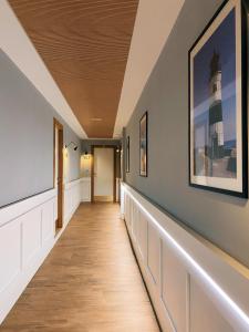 a hallway with a staircase with a lighthouse painting on the wall at Residence Ten Suite in Rimini