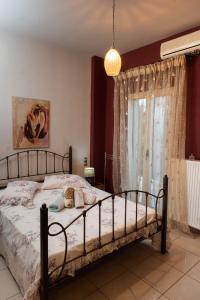 a bedroom with a bed and a window at House with Garden near the Beach in Heraklio