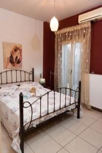 a bedroom with a bed and a window at House with Garden near the Beach in Heraklio