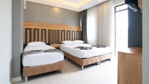 Postel nebo postele na pokoji v ubytování Kafkas Hotel
