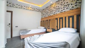 Postel nebo postele na pokoji v ubytování Kafkas Hotel