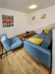a living room with a blue couch and a table at Gallery Apartments in Liberec