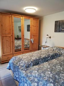 a bedroom with a bed and some wooden cabinets at Hyggelig in Kosel