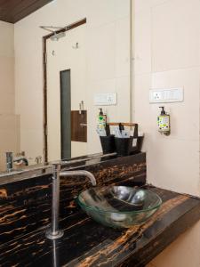 a bathroom with a sink and a mirror at Hotel Aura - Near Malad Link Road in Mumbai