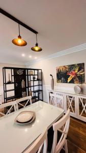 a dining room with a white table and chairs at Sodic Westown Residence 3 in Sheikh Zayed